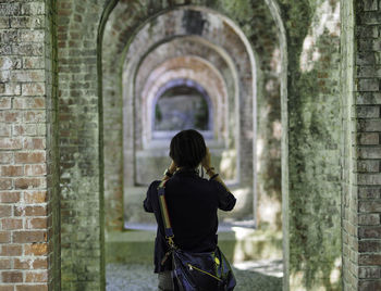 Woman standing in front of building