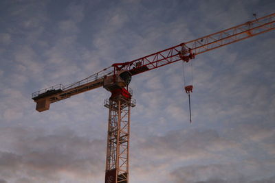 Low angle view of crane against sky
