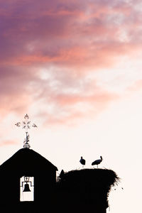 Low angle view of silhouette birds against sky