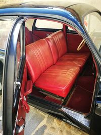 Close-up of red seats in bus