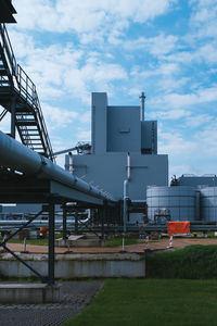 Low angle view of factory against sky