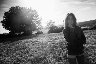 Portrait of woman standing on field