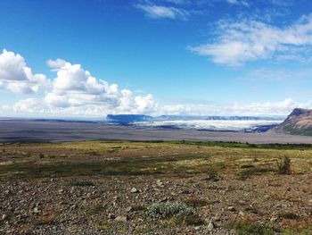 Scenic view of landscape against cloudy sky