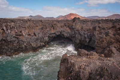 Scenic view of rocks in sea against sky