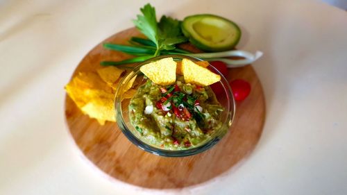 High angle view of a guacamole dip in bowl on table