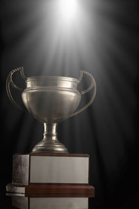 Close-up of trophy on table against illuminated lights