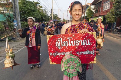 Portrait of smiling woman standing on street