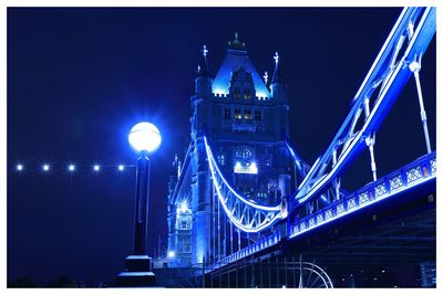 Low angle view of suspension bridge at night