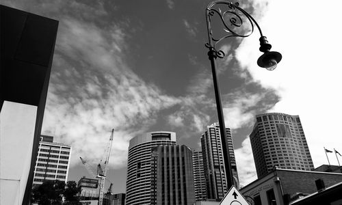 Low angle view of modern building against cloudy sky