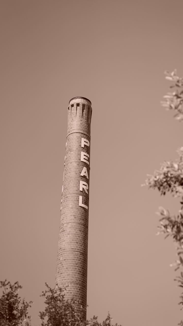 LOW ANGLE VIEW OF SMOKE STACK AGAINST CLEAR SKY
