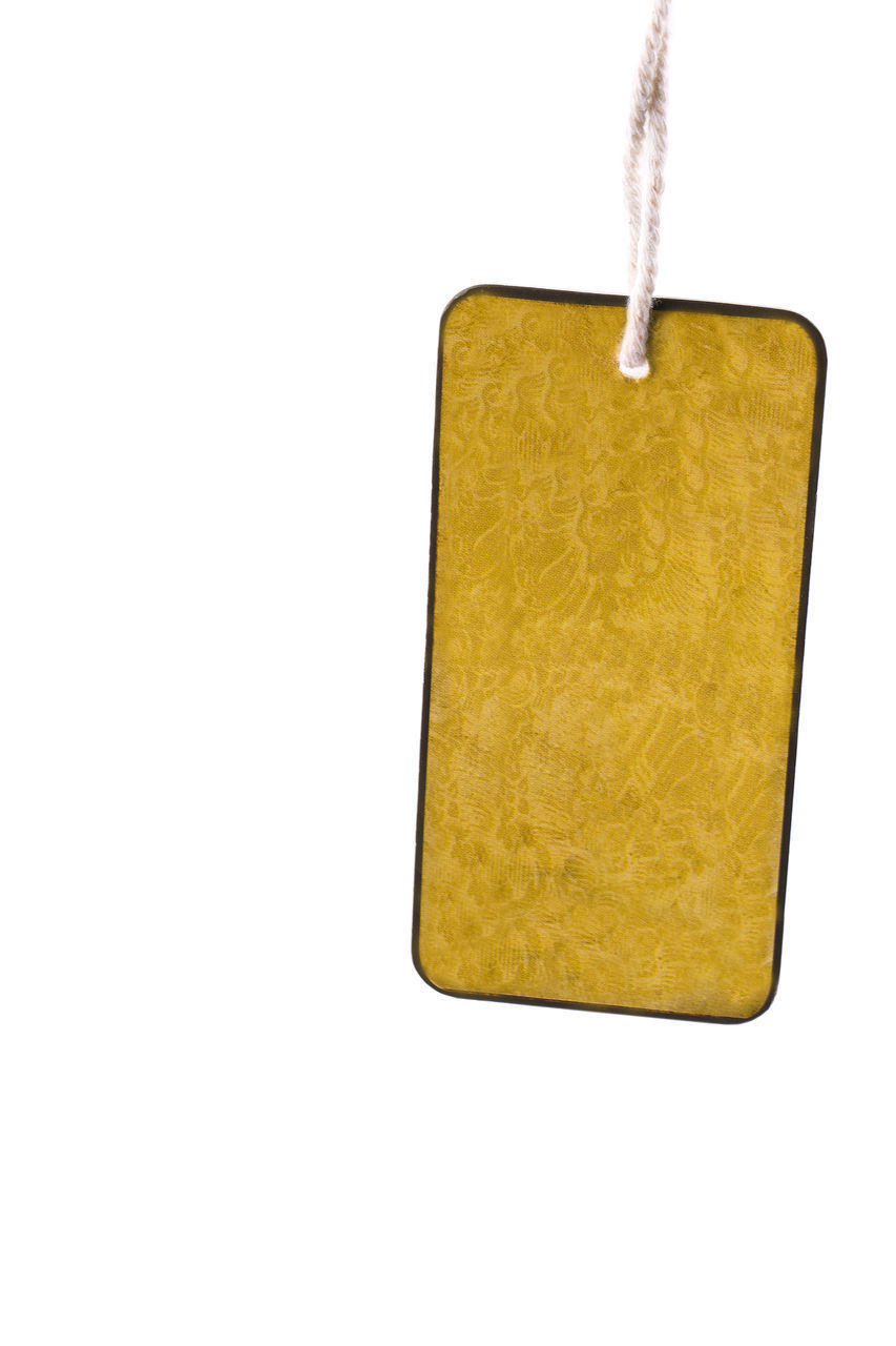 LOW ANGLE VIEW OF YELLOW PAPER HANGING ON WHITE BACKGROUND