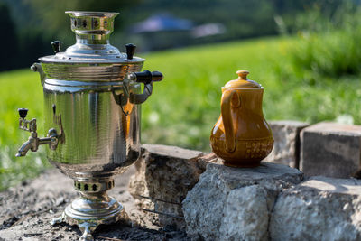 Close-up of old lantern on field