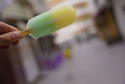 Close-up of hand holding ice cream