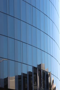 Low angle view of office building against blue sky