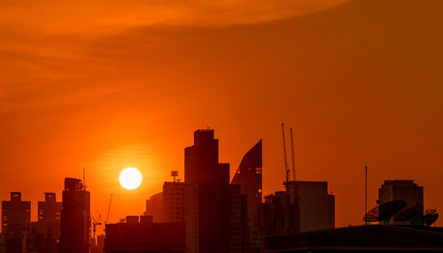 Business building in downtown at dusk with beautiful sunset sky. silhouette of condo and apartment