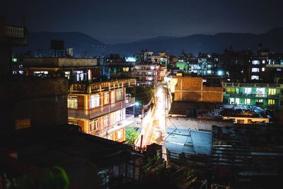 View of illuminated cityscape against sky at night