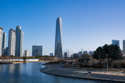 View of modern buildings against clear blue sky