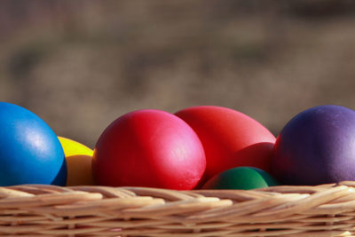 Close-up of multi colored eggs in basket