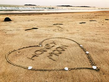 High angle view of text on beach