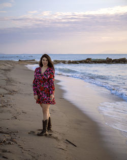 Full length of woman on beach against sky