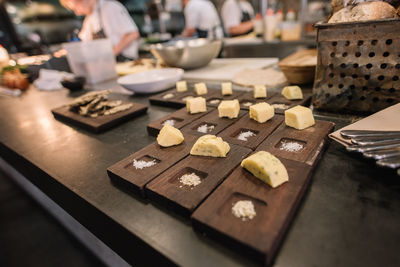 Cheese on wood over table in restaurant