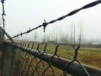 Barbed wire fence on field