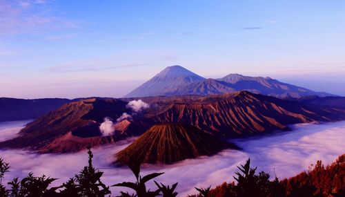 Scenic view of snowcapped mountains against sky during sunset