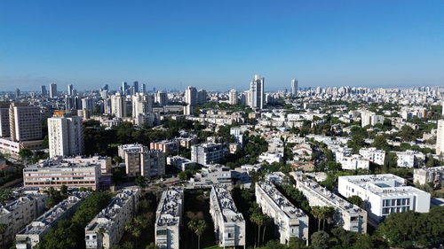 High angle view of cityscape against clear blue sky