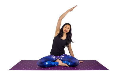 Full length of smiling young woman against white background