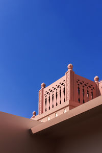 Low angle view of building against clear blue sky