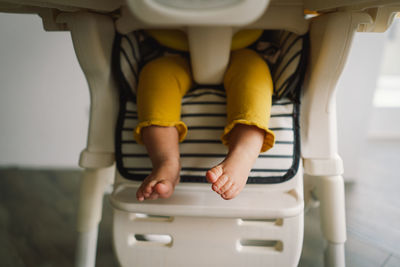 Rear view of woman sitting on chair