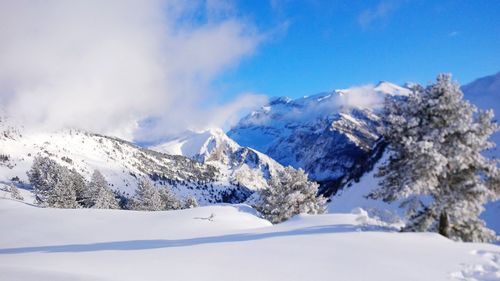 Scenic view of snowcapped mountains against sky