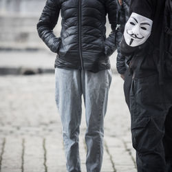 Two activists during a demonstration with a mask of anonymous