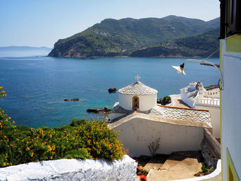 Scenic view of sea and mountains against sky