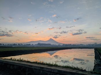 Scenic view of lake against sky during sunset