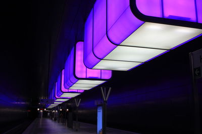 Illuminated lights on ceiling of building at night