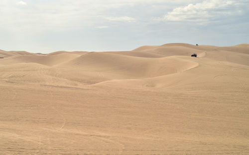 Atv off-road all terrain vehicles driving over the sand dunes imperial sand dunes california 