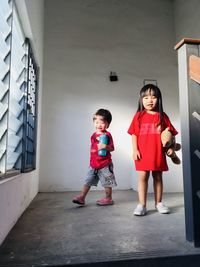 Full length of friends standing in corridor