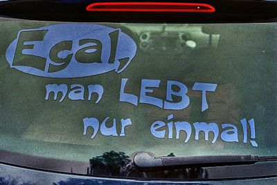 Close-up of text on glass window