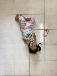 High angle of girl lay on the floor