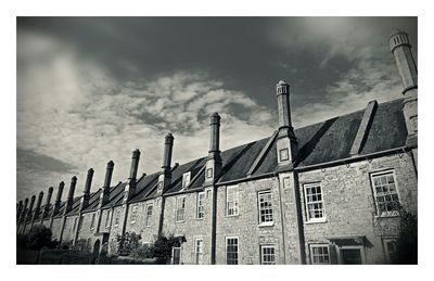 Low angle view of building against cloudy sky