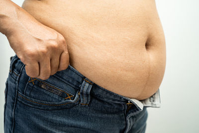 Midsection of man holding abdomen