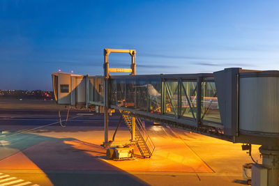 Metallic structure against sky at sunset