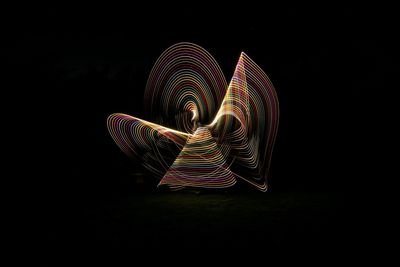 Illuminated light painting against black background