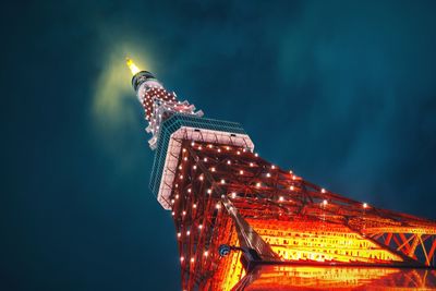 Low angle view of illuminated tokyo tower against sky at night