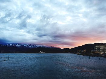 Scenic view of river against cloudy sky