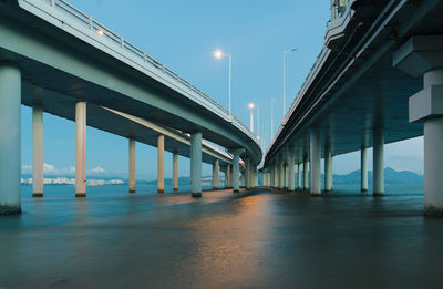 Illuminated bridge against sky in city at night