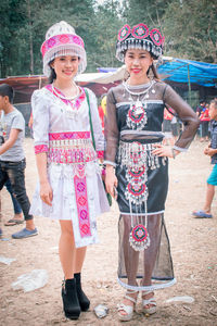 Full length portrait of girl standing outdoors