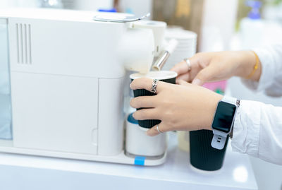 Cropped hand of person using sewing machine