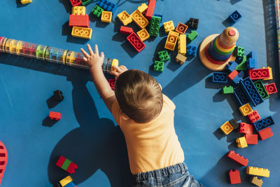 High angle view of girl playing with toy